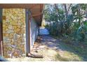 Stone exterior wall and side yard with access gate at 2309 Lime Tree Dr, Edgewater, FL 32141