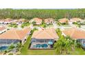A beautiful backyard with a screened-in pool and spa with view of the tile roof at 2824 S Asciano Ct, New Smyrna Beach, FL 32168