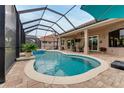 Beautiful screened-in pool and spa area perfect for outdoor relaxation and entertainment at 2824 S Asciano Ct, New Smyrna Beach, FL 32168