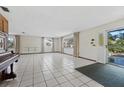 Bright living room featuring tiled floors and patio access at 3120 Pine Tree Dr, Edgewater, FL 32141