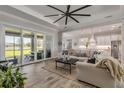 Spacious living room with sliding glass doors leading to a patio and a view of a lake at 3203 Monaco Blvd, New Smyrna Beach, FL 32168