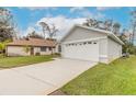 One-story home with attached garage and expansive driveway at 3441 Gaveson Ct, Port Orange, FL 32129