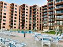 Inviting pool area with lounge chairs and tables at 4141 S Atlantic Ave # 602, New Smyrna Beach, FL 32169