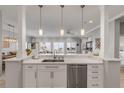 Modern white kitchen with quartz counters and ocean view at 423 S Atlantic Ave # 101, New Smyrna Beach, FL 32169