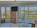 Living room with water views and sliding door to balcony at 434 Bouchelle Dr # 202, New Smyrna Beach, FL 32169