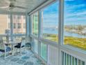 Relaxing screened porch with water views and seating area at 434 Bouchelle Dr # 202, New Smyrna Beach, FL 32169