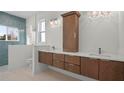 Modern bathroom with double vanity, wood cabinets, and a walk-in shower at 437 S Peninsula Ave, New Smyrna Beach, FL 32169