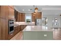 Modern kitchen with wood cabinets, quartz countertops, and stainless steel appliances at 437 S Peninsula Ave, New Smyrna Beach, FL 32169