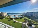 Oceanfront condo balcony view with pool and lush landscaping at 4501 S Atlantic Ave # 5180, New Smyrna Beach, FL 32169