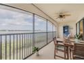 Relaxing screened balcony with water views, ceiling fan and outdoor furniture for enjoying the outdoors at 456 Bouchelle Dr # 202, New Smyrna Beach, FL 32169