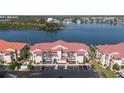 Exterior of the complex showcasing waterfront condos, assigned parking, and tropical landscaping at 456 Bouchelle Dr # 202, New Smyrna Beach, FL 32169