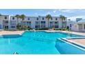 Inviting community pool with surrounding lounge chairs at 4590 S Atlantic Ave # 258A, Ponce Inlet, FL 32127