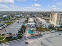 Aerial view of a coastal community with multiple buildings, pool, and beach access at 505 N Atlantic Ave # 29, New Smyrna Beach, FL 32169