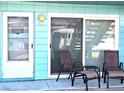 Inviting patio with two chairs and a small table at 541 S Peninsula Ave # A03, New Smyrna Beach, FL 32169