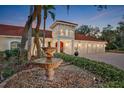 Impressive home entrance with fountain and lush landscaping at 817 Hail Ct, Port Orange, FL 32127