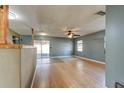 Living room with bamboo flooring, ceiling fan, and access to the kitchen at 84 Tumbler Dr, Port Orange, FL 32129