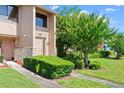 Inviting townhouse exterior with lush landscaping, stone accents, and a cozy entrance at 105 Wood Duck Cir # 1C, Daytona Beach, FL 32119