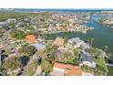 Wide aerial view of a waterfront community with many houses and waterways at 107 Via Amalfi, New Smyrna Beach, FL 32169