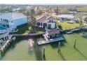 Aerial view of house, private dock, and boat slip on the waterfront at 107 Via Amalfi, New Smyrna Beach, FL 32169