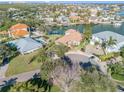 Aerial view showcasing a waterfront property, multiple houses, and a canal at 107 Via Amalfi, New Smyrna Beach, FL 32169