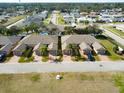 Aerial view of community showing multiple tan houses with garages at 108 Tuscany Villas Dr # 15, Edgewater, FL 32141