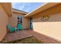 Brick paved patio with teal chairs and a small table at 108 Tuscany Villas Dr # 15, Edgewater, FL 32141