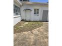 Small patio area with overgrown weeds at 1132 Australia Ave, Daytona Beach, FL 32114