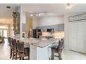 Modern kitchen with granite countertops, gray cabinets, and stainless steel appliances at 1155 Kilkenny Ln, Ormond Beach, FL 32174