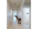 Long hallway with tile flooring and access to other rooms at 126 Old Mill Pond Rd, Edgewater, FL 32141