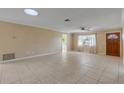 Bright living room with tile floors and a ceiling fan at 1732 Travelers Palm Dr, Edgewater, FL 32132