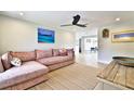 Living room with sectional sofa, large TV and view into dining area at 2307 Saxon Dr, New Smyrna Beach, FL 32169