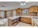 L-shaped kitchen with wood cabinets and white countertops at 2515 Fairfax Ave, New Smyrna Beach, FL 32168