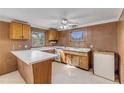 L-shaped kitchen with wood cabinets and white countertops at 2515 Fairfax Ave, New Smyrna Beach, FL 32168