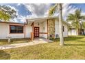 Welcoming entrance with a decorative front door and stone accent wall, enhancing curb appeal at 2712 Queen Palm Dr, Edgewater, FL 32141