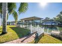 Private dock with covered seating area, perfect for relaxing by the water at 275 Randle Ave, Oak Hill, FL 32759