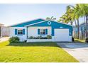 Charming beach cottage with blue accents and lush lawn at 275 Randle Ave, Oak Hill, FL 32759