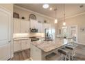 Modern kitchen with white cabinets, granite countertops, and stainless steel appliances at 3012 Portofino Blvd, New Smyrna Beach, FL 32168