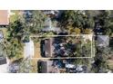 Aerial view of property with a well-defined perimeter, mature trees, and driveway to the garage at 314 Hillman St, New Smyrna Beach, FL 32168
