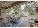 Inviting covered patio with stylish seating, a ceiling fan, and lush garden views at 314 Hillman St, New Smyrna Beach, FL 32168