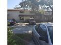 View of the two-story building's exterior showing parking, trees, and landscaping at 322 Canal Rd # 16, Edgewater, FL 32132