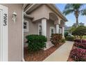 Front entryway with a covered porch, columns and neatly trimmed shrubs at 323 Mariners Gate Dr, Edgewater, FL 32141