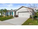 Front view of a single story house with a two car garage at 3257 Carpentaria Dr, New Smyrna Beach, FL 32168