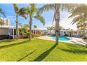 Large backyard with lush lawn, palm trees, and a sparkling pool at 3862 Cardinal Blvd, Port Orange, FL 32127