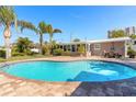 Relaxing kidney-shaped pool with patio and tropical landscaping at 3862 Cardinal Blvd, Port Orange, FL 32127