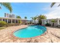 Kidney-shaped swimming pool with brick pavers and lush landscaping at 3862 Cardinal Blvd, Port Orange, FL 32127