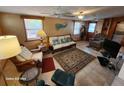 Cozy living room featuring wood furniture, a large TV, and tiled floors at 4650 Saxon Dr, New Smyrna Beach, FL 32169