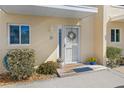 Beach condo front door entrance with plants and wreath at 4773 S Atlantic Ave # 10, Ponce Inlet, FL 32127