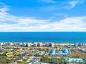 Aerial view showing home's proximity to beach at 50 Pompano Dr, Ponce Inlet, FL 32127