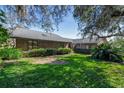 Landscaped front yard with brick house at 507 Boxwood Ln, New Smyrna Beach, FL 32168