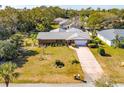 Single-story home with a large yard and driveway, aerial view at 51 Club House Blvd, New Smyrna Beach, FL 32168